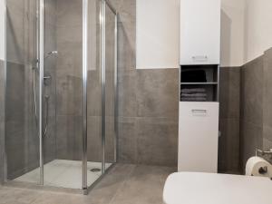 a shower with a glass door in a bathroom at Wohnung Forst in Forst