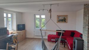 a living room with a red couch and a tv at Vila Galant in Konice