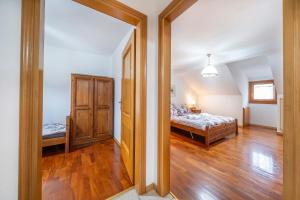 a bedroom with a bed and a mirror in a room at Penthouse Central apartments vista Monte Priesnig in Tarvisio