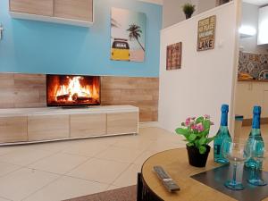 a living room with a fireplace and a table at LOFT Centrico Santander - RH Altamar in Santander