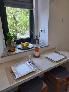 a kitchen counter with a table with two plates and a window at Tiny House for 2 Hreljin Crikvenica in Hreljin