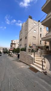 a building with stairs in front of a street at ELIAS Penthouse in Nazareth
