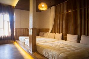 Postel nebo postele na pokoji v ubytování Pariban Hotel + 21 fotografií