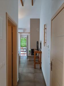 a hallway with a door and a table and a television at Niki Apartments Beach Loft in Platamonas