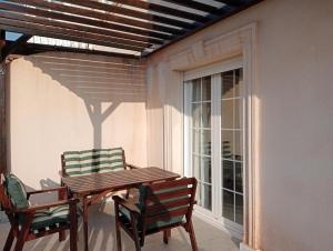 a wooden table and two chairs on a patio at Balcón al mar in Adra