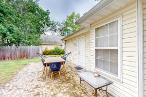 a patio with a table and chairs next to a house at 1990's Classic in North Myrtle Beach