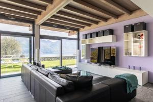 a living room with a couch and a large window at Villa Nicolette sleeps 8 in Menaggio