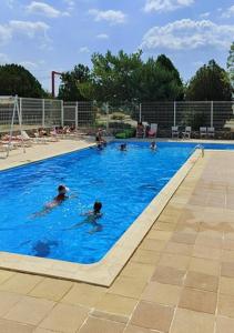 a group of people swimming in a swimming pool at Mobilhome à Sainte Croix Du Verdon in Sainte-Croix-de-Verdon