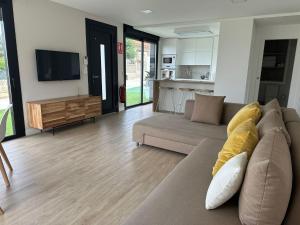 a living room with a couch and a tv at Lagarteira in Sanxenxo