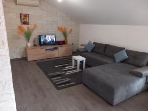 a living room with a couch and a tv at Marija in Korčula