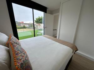 a bedroom with a bed and a large window at Lagarteira in Sanxenxo +30 photos