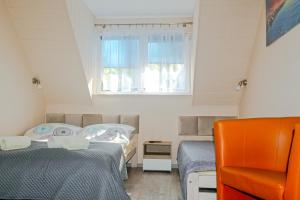 Postel nebo postele na pokoji v ubytování Sztil - Apartamenty i drewniane domki