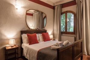 a bedroom with a bed with a mirror on the wall at Borgo Dolciano in Chiusi +213 photos