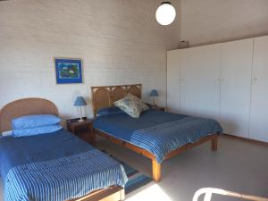 a bedroom with two beds in a room at Our holiday home at the beach in Port Alfred