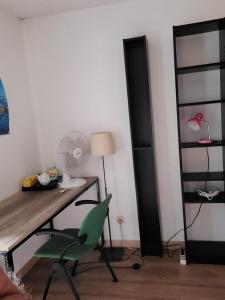 a room with a desk and a green chair at Le Loft in Montpellier +24 photos