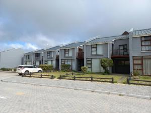 a row of houses with a car parked in the street at Our holiday home at the beach in Port Alfred