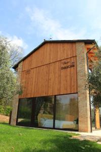 a building with a large window with a bed in it at Chalet Dolce Colle in Volpago del Montello +24 photos