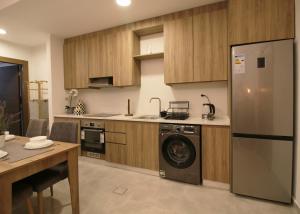 a kitchen with a washer and a dishwasher in it at KAYO Residence in Amman