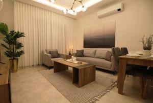 sala de estar con sofá y mesa en KAYO Residence en Amán