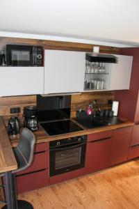 a kitchen with a sink and a stove at Hausboot Wangermeer Nordsonne12 mit Sauna in Wangerland