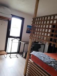 a room with a bunk bed and a desk and a window at Le Loft in Montpellier
