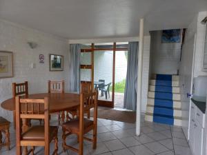 a kitchen and dining room with a table and chairs at Our holiday home at the beach in Port Alfred
