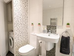 a white bathroom with a sink and a toilet at Kingfisher Lodge in Great Yarmouth +7 photos