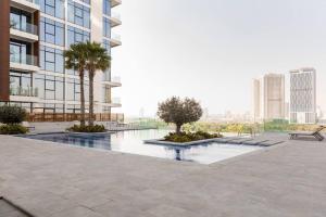 a courtyard with two palm trees and a building at 1 Bed Near Zabeel-Park Shiekh Zayed Rd world-Trade center in Dubai