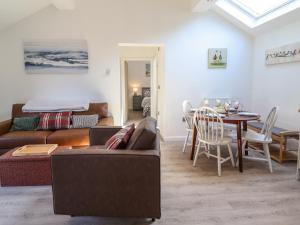 a living room with a couch and a table at Tan Llech in Harlech