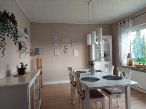 a kitchen and dining room with a table and chairs at Ferienhaus Weitblick in Olsberg