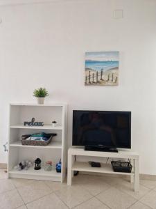 a white entertainment center with a flat screen tv at Apartment Relax - 80 m from the beach in Sveti Filip i Jakov