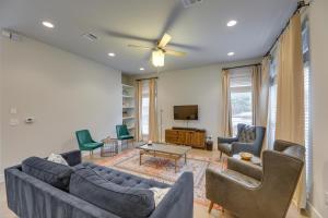 a living room with a couch and chairs and a tv at Chic Austin Vacation Rental Condo Near Downtown! in Austin