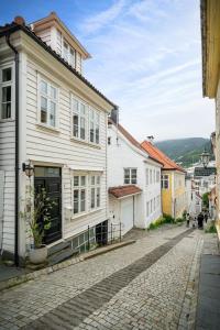 a cobblestone street in a town with white buildings at Central studio basement apartment in Bergen