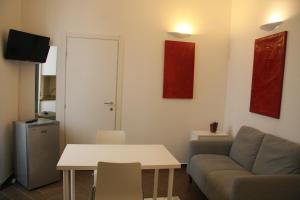 a living room with a couch and a table at Palazzo della Poesia Casa Vacanze in Salerno