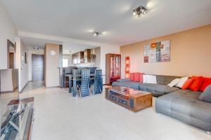 a living room with a couch and a table at Gina s Sun Terrace in Playa Paraiso