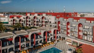 an aerial view of a building with a swimming pool at Muthu Oura Praia Hotel in Albufeira