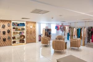 a clothing store with chairs and racks of clothes at Constantinos the Great Beach Hotel in Protaras +132 photos