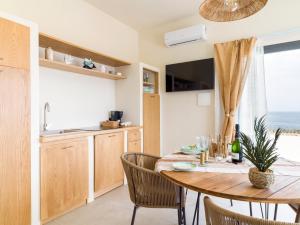 a kitchen and dining room with a table and chairs at Kartika Charming House in Lampedusa