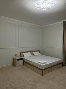 a bedroom with a large bed in a room at Hotel Bereke in Atyrau