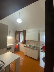 a kitchen with a sink and a washing machine at Casa di don Francesco in Scala
