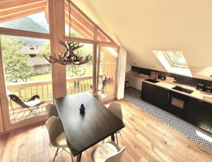 a kitchen and dining room with a table and chairs at Alpen Lodge in Osterhofen - Berge, Ruhe & Natur in Bayrischzell