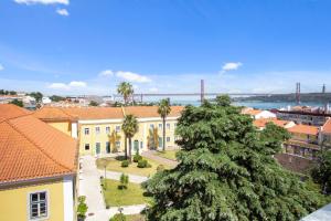 a view of a city with a bridge in the background at Brand New River View Apartment Belém - 1 bedroom, A/C in Lisbon