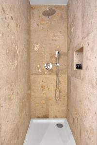 a shower with a shower head in a bathroom at Brand New River View Apartment Belém - 1 bedroom, A/C in Lisbon