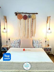 a bedroom with a white bed with hanging decorations at TravelHome Serviced Apartment LPA Airport - Business - Time Off in Playa del Burrero