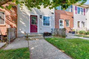 a house with a red door and a fence at Modern Newark Vacation Rental Near Downtown! in Newark