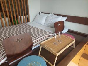 a small room with a bed with a table and chairs at Seanna's Place at Pico de Loro in Nasugbu