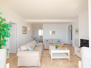 a living room with a couch and a table at Apartment Les Dauphins-1 by Interhome in Sainte-Maxime