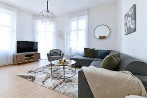 a living room with a couch and a table at At Home in Colmar - City center in Colmar