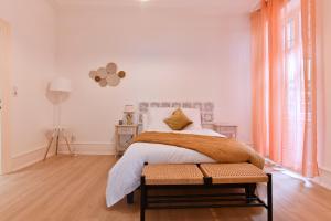 a bedroom with a bed and a large window at At Home in Colmar - City center in Colmar