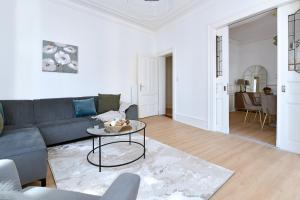 a living room with a couch and a table at At Home in Colmar - City center in Colmar